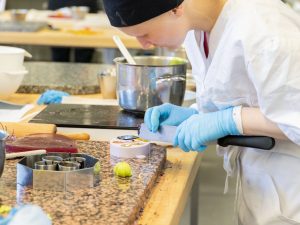 Opiskelija irrottaa sokerista koristetta muotista